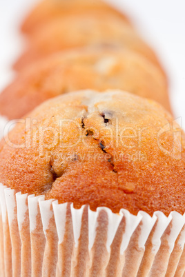 Close up on four muffins in line