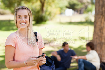 Portrait of a smiling girl using a smartphone