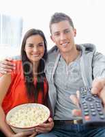 Close up focus shot on the couple sitting on the couch with popc