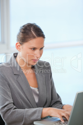 Businesswoman typing on a computer
