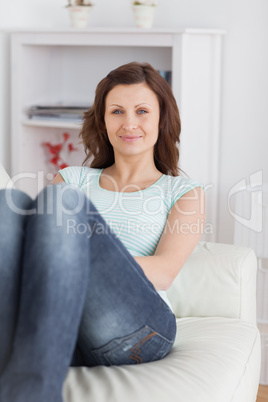 Woman sitting on a sofa looking at camera