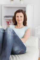 Woman sitting on a sofa looking at camera