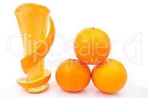 Orange peel wrapped around a glass near a pile of oranges