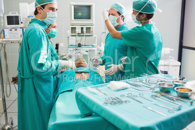 Surgeon operating an uncounscious patient in an operating theate