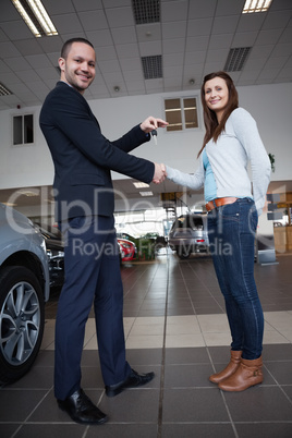 Man shaking hand with woman