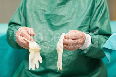 Surgeon holding surgical gloves