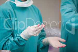 Nurse holding a surgical scissor