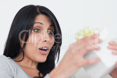 Surprised woman opening a gift box