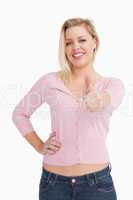Woman standing upright while placing her thumbs up