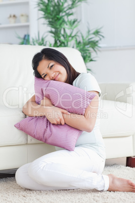 Woman holding tight a pillow