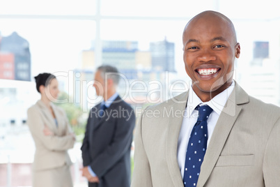 Young manager standing upright while smiling