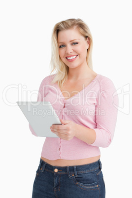 Smiling woman holding her tablet computer