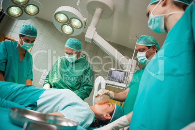 Surgeon holding a mask on the face of a woman