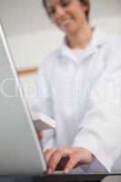 Pharmacist typing on a laptop