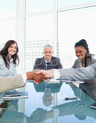 Businesswomen smiling during a meeting while looking at colleagu