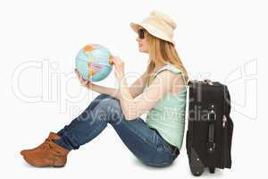 Woman holding a world globe while sitting