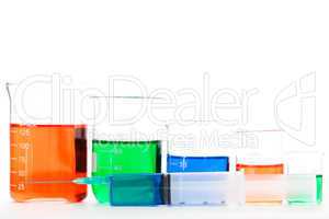 Five beakers behind a syringe