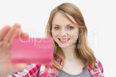 Woman holding a loyalty card while looking at camera