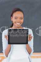Smiling black woman holding a tablet computer