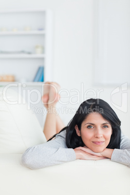 Woman with her head resting on her crossed arms