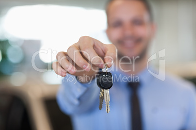 Man holding car keys by his fingertips