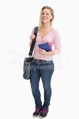 Smiling young woman holding a shoulder bag