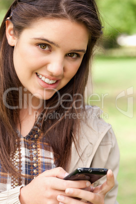 Portrait of a cute teenager using a smartphone