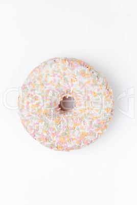 Extreme close up of a doughnut with multi coloured icing sugar
