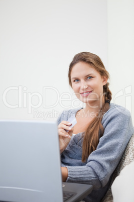 Woman sitting while using her tablet computer