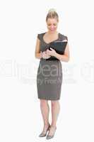 Businesswoman looking at notepad in her hands