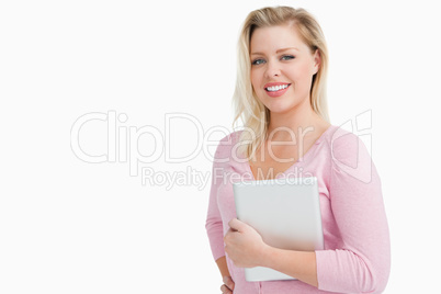 Joyful blonde woman holding her tablet computer