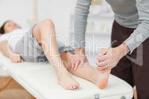 Physiotherapist stretching a barefoot