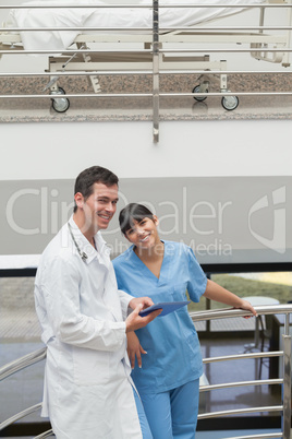 Doctor holding a tablet computer next to a nurse