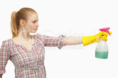 Joyful woman holding a spray bottle