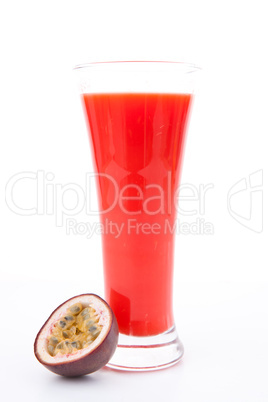 Full glass of berries juice near a passion fruit