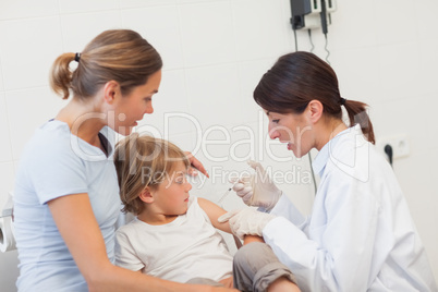 Child receiving an injection by a doctor