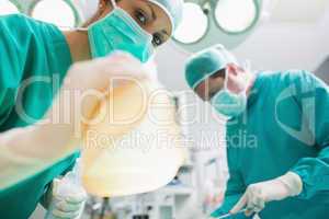 Close up of a nurse holding an anesthesia mask