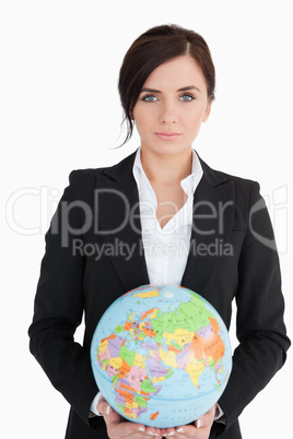 Beautiful woman in suit holding an earth globe