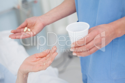 Nurse giving drugs to a patient