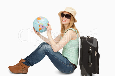 Woman holding a world globe while smiling