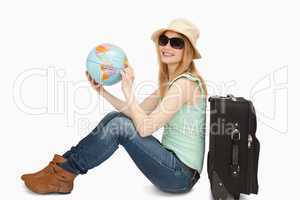 Woman holding a world globe while smiling