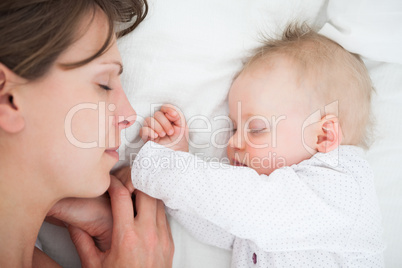 Peaceful woman lying on a bed with her daughter