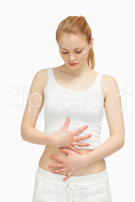 Woman placing her hands on her stomach