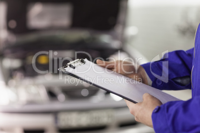 Close up of a man holding a clipboard