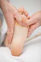 Chiropodist massaging the foot of a patient