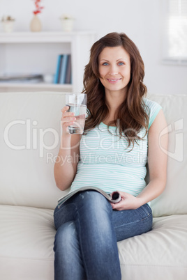 Woman holding a glass while smiling Woman holding a glass while smiling