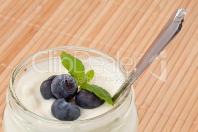 Close up of four blueberries in a yogurt