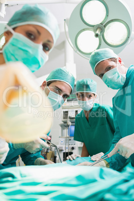Surgeons and nurses looking at camera