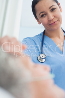 Smiling nurse looking at a patient
