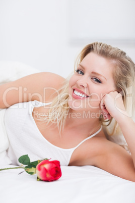 Woman with a rose smiling
